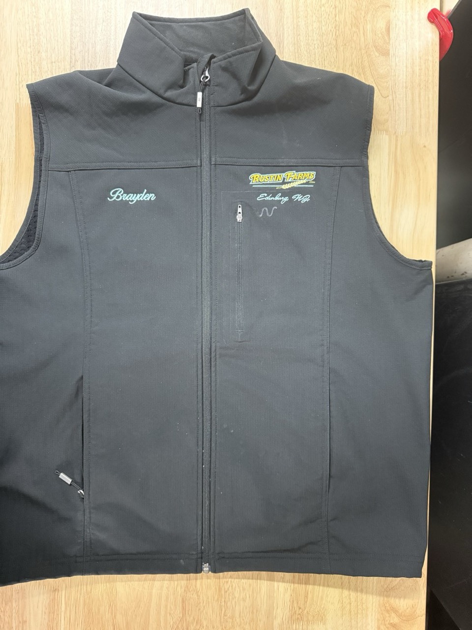 Custom left-chest embroidery on a softshell vest by Meadow Prints and Embroidery